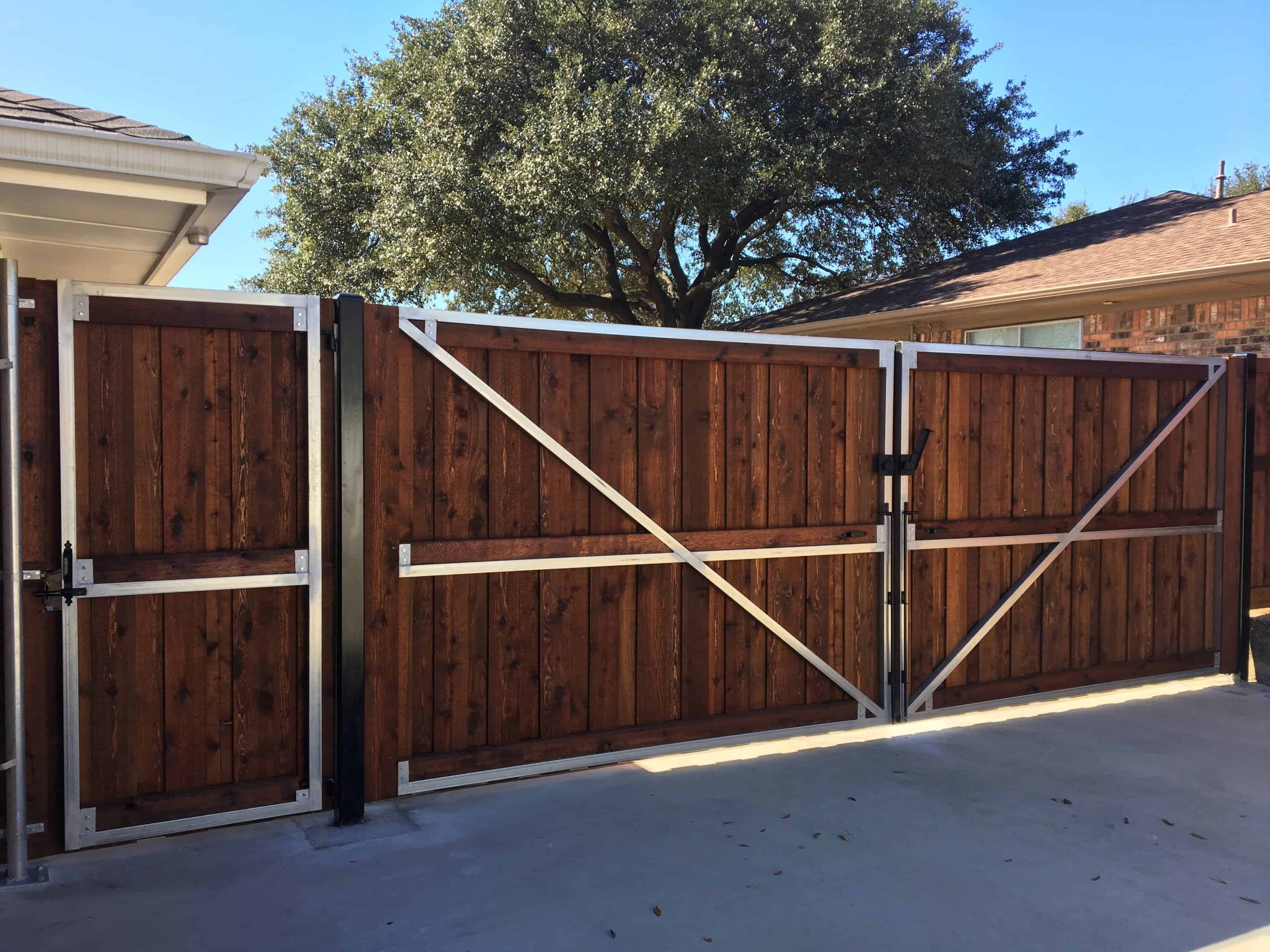 Custom wood driveway gate installation in North Texas