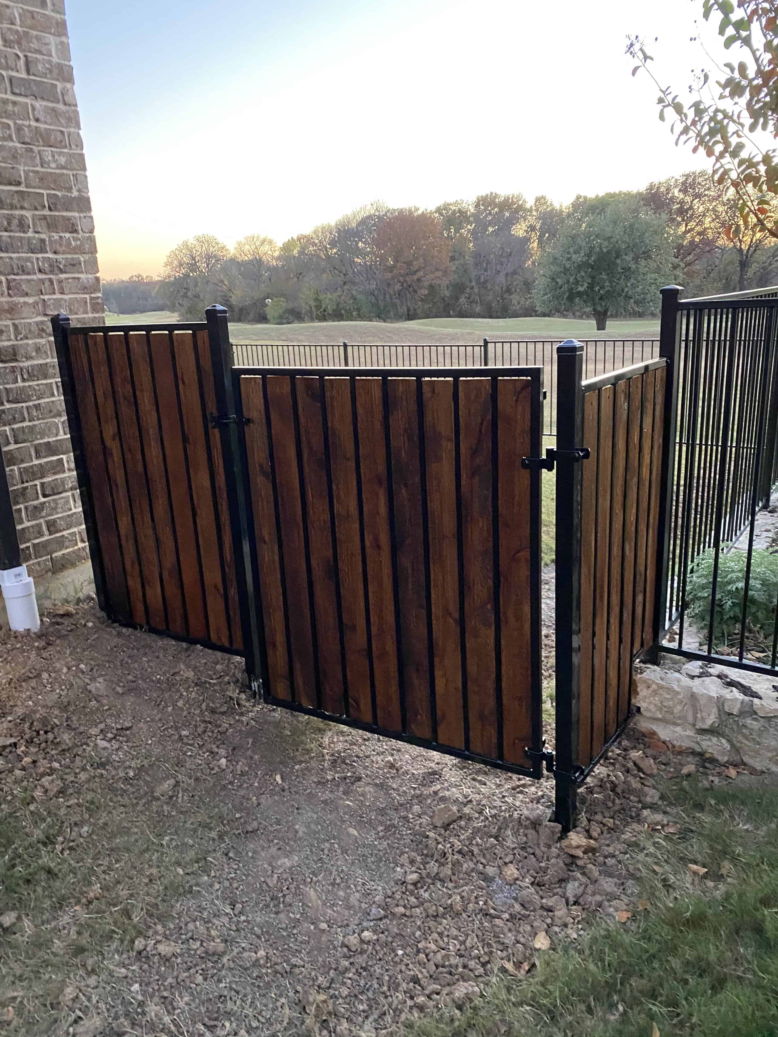 Stepped flat top steel fence with cedar accents