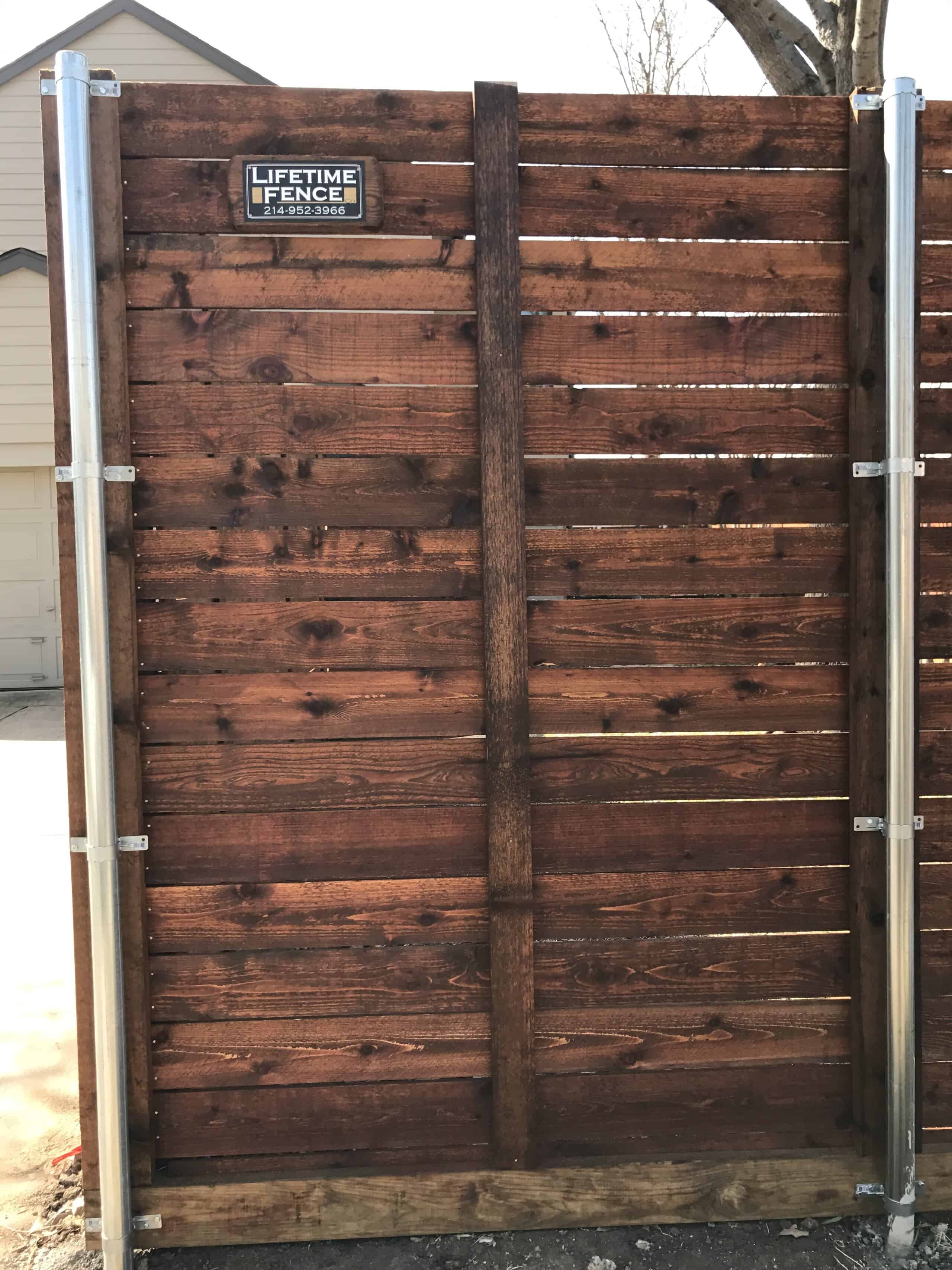 Cedar fence with galvanized steel posts set in concrete