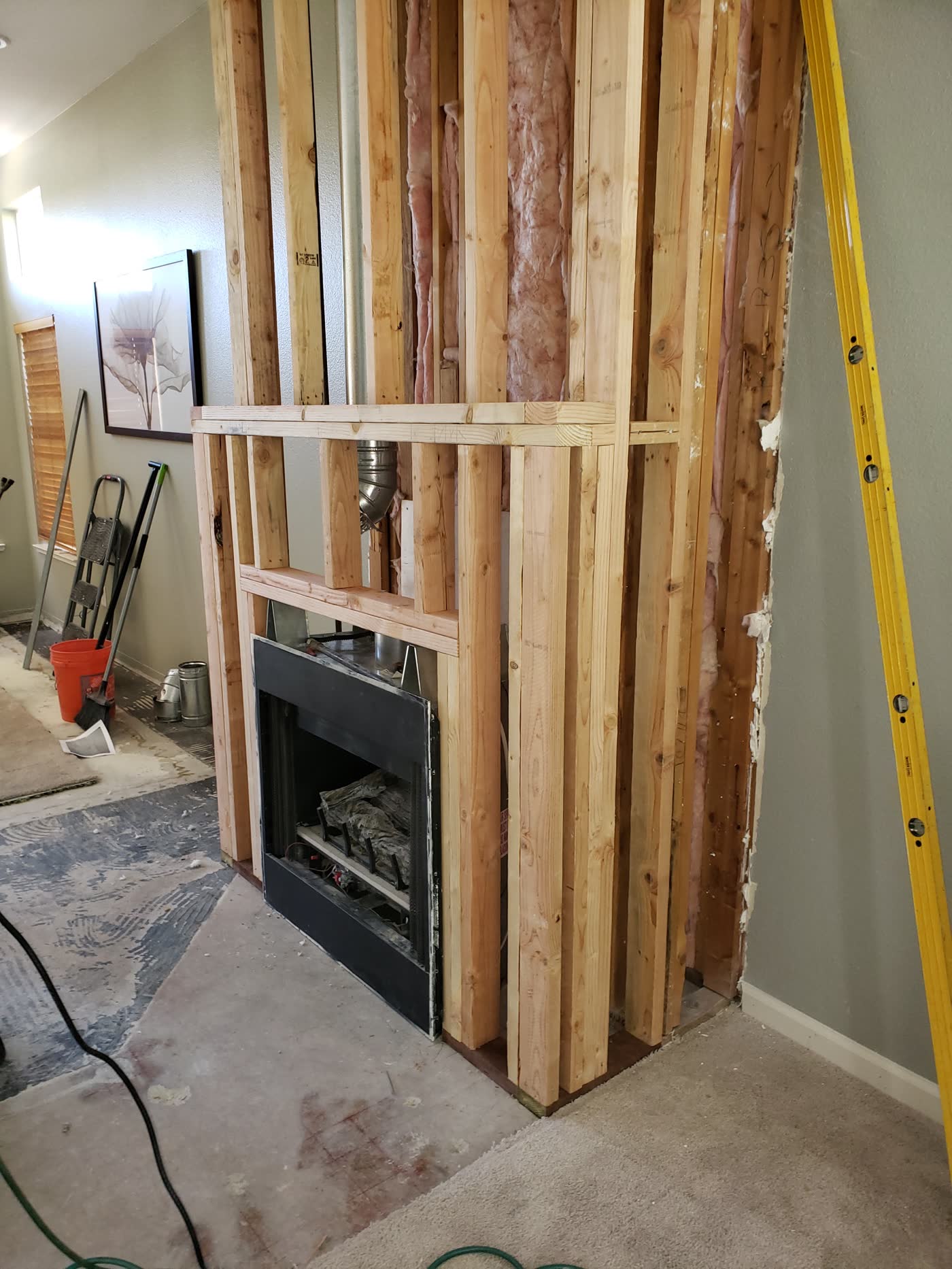In-progress fireplace framing and gas insert installation
