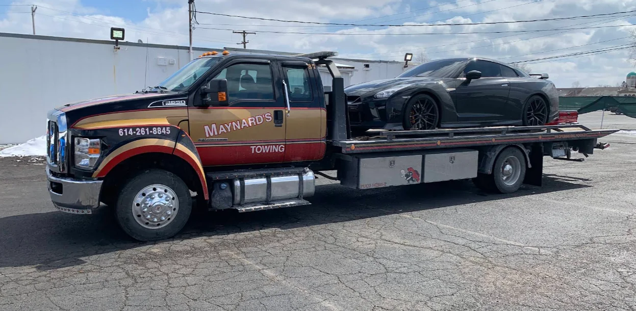Maynard's flatbed carrying a performance coupe