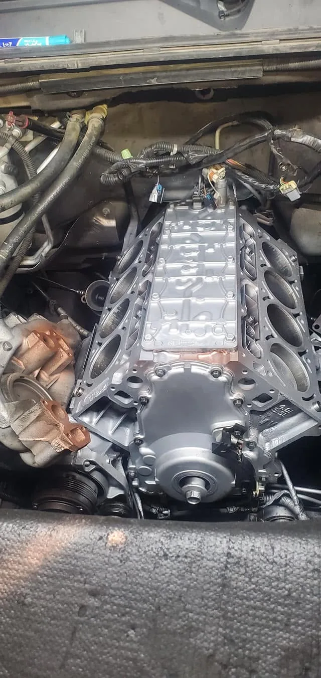 Engine repair and timing assembly work in progress at an auto repair shop